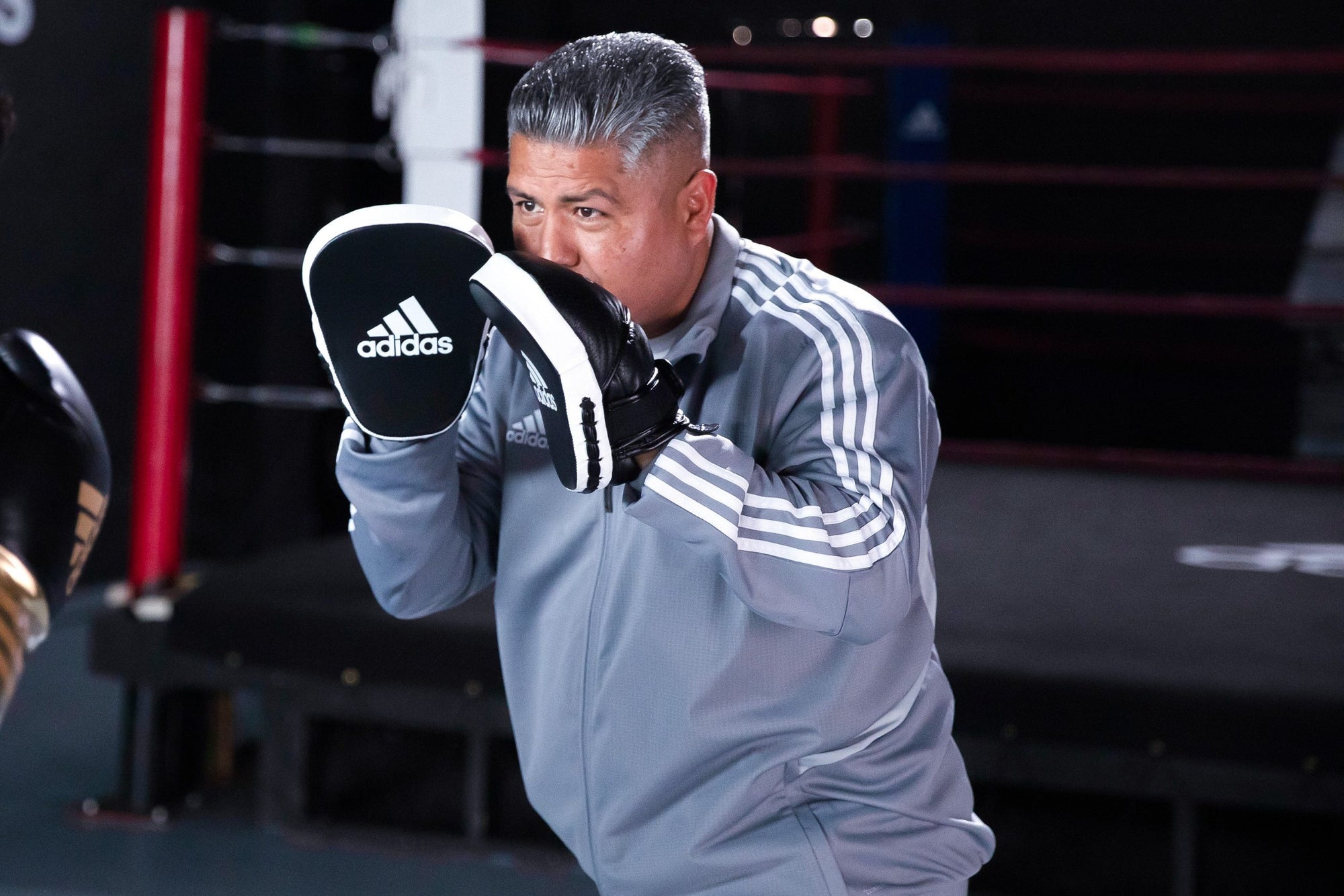 A man wearing boxing gloves during training.