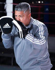 A man wearing boxing gloves during training.