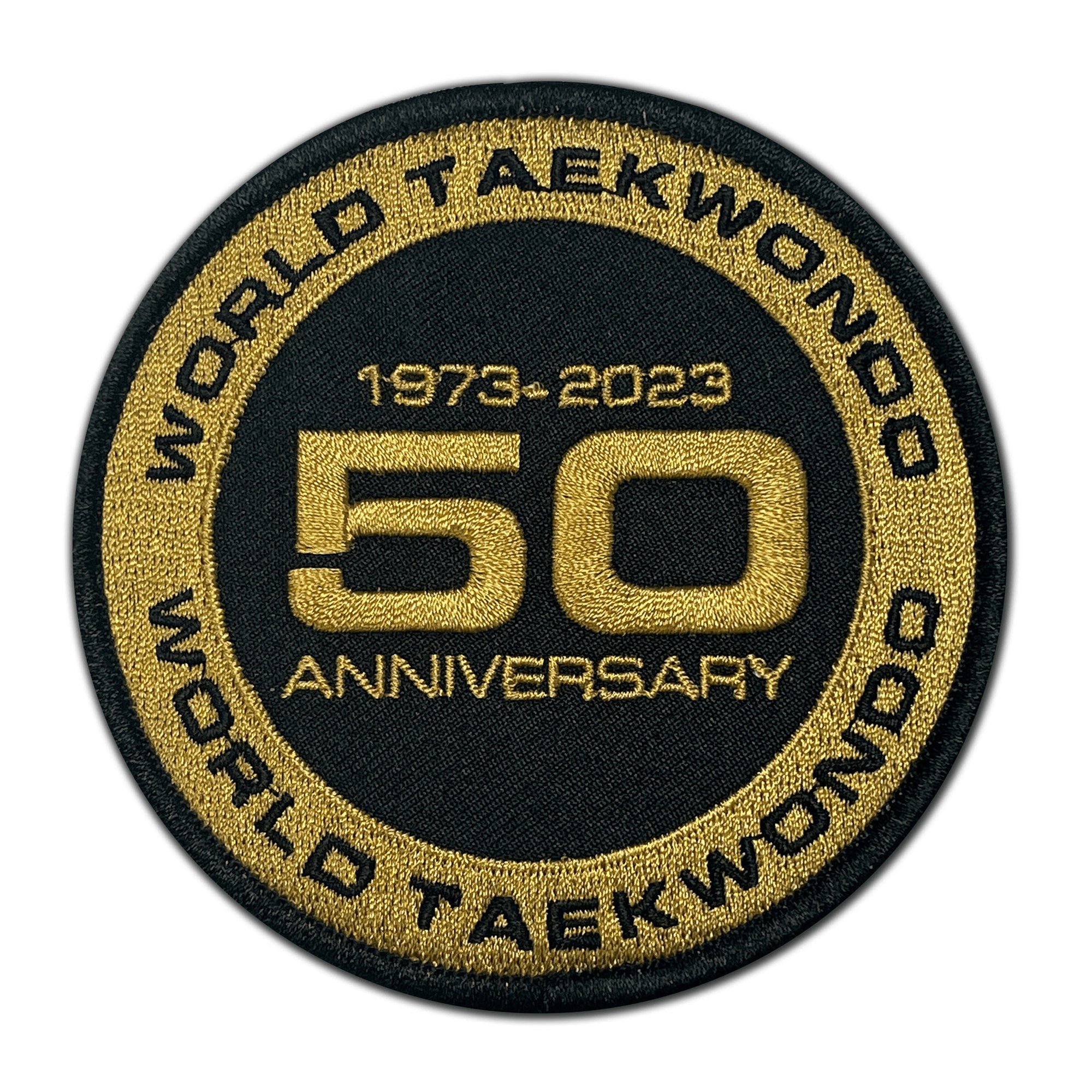 Black and gold patch with a number, celebrating World Taekwondo 50th Anniversary.