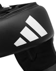 Black boxing helmet with white logo, small to medium size.