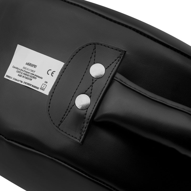 Close-up of a black kick shield for boxing training.