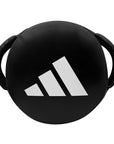 Black round kick shield with white logo.