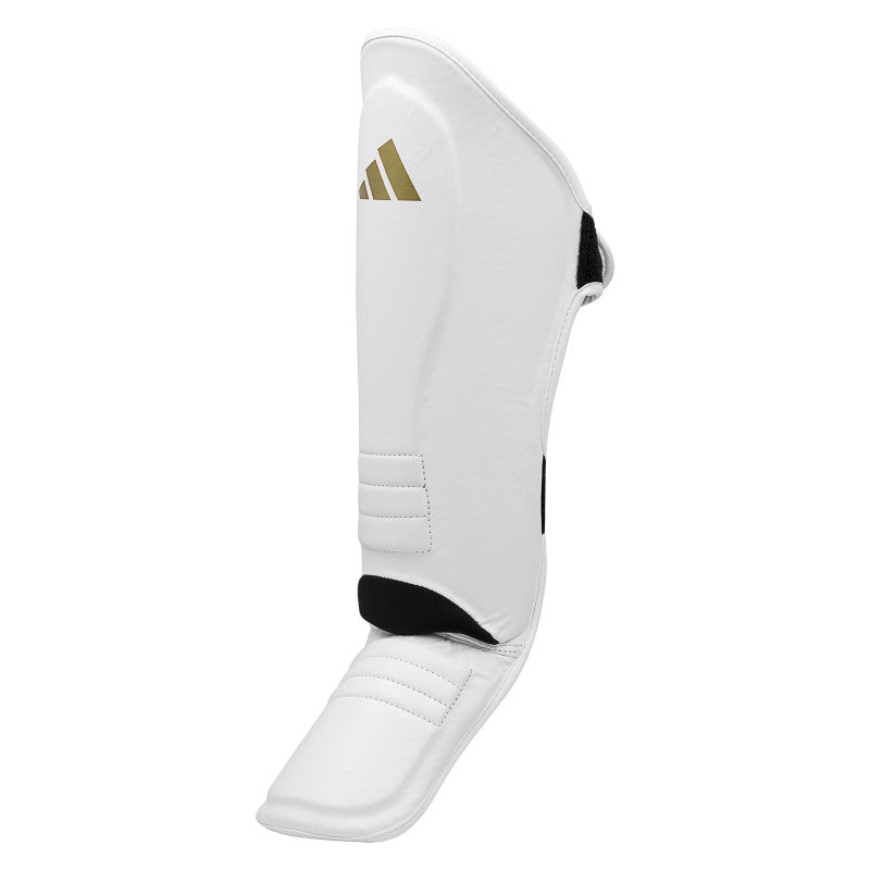 White shin guard with black and gold logo for boxing protection.