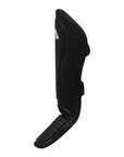 Black shin guard on white background, suitable for boxing.