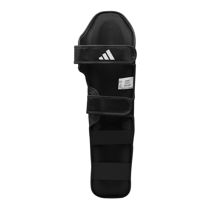 Black shin guard for boxing on white background.