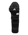 Black shin guard for boxing on white background.