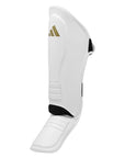 White shin guard with black and gold logo for boxing protection.