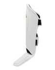 White shin guard with black straps, medium size for boxing.