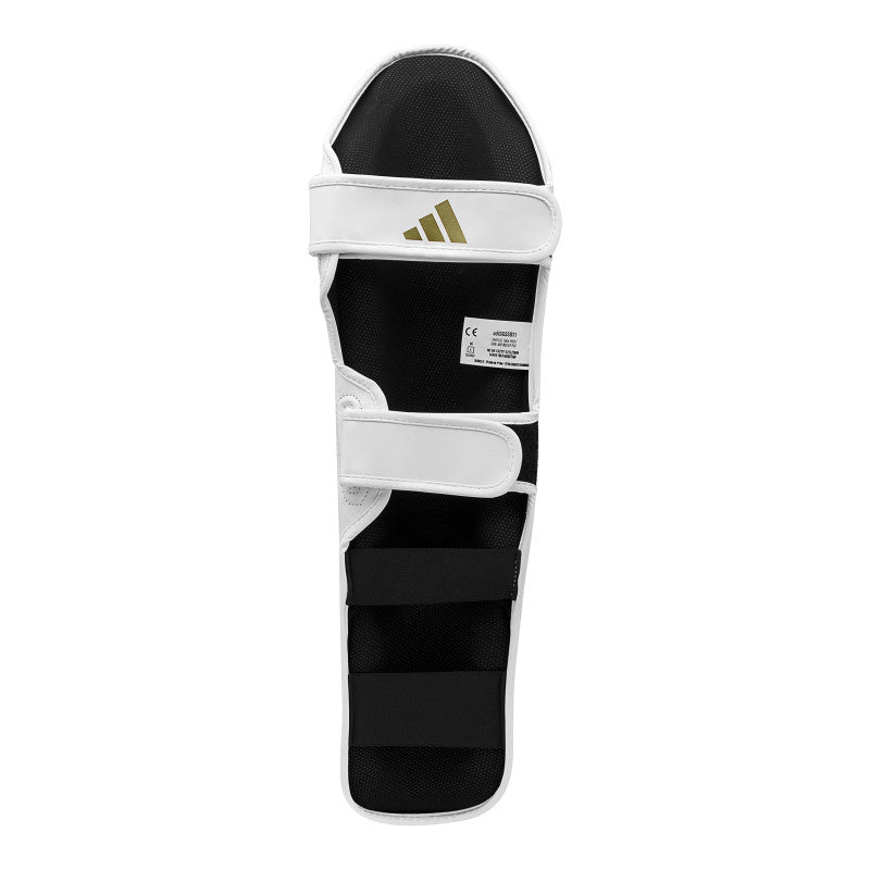 Black and white leg guard for boxing equipment.