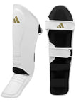 White shin guard with black straps for boxing.