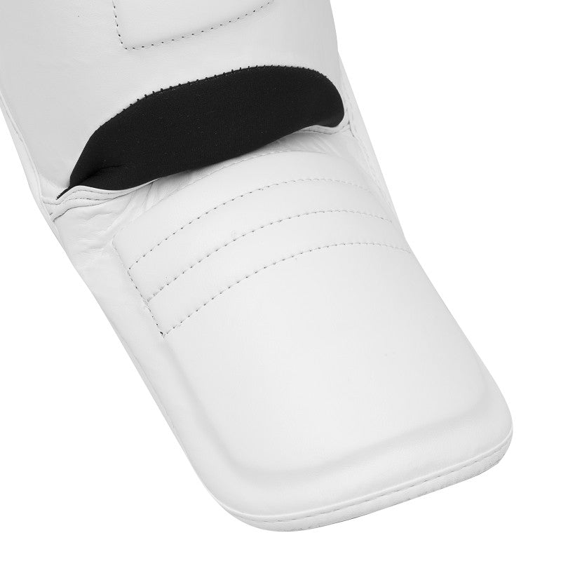 A white glove with a black glove inside for boxing protection.