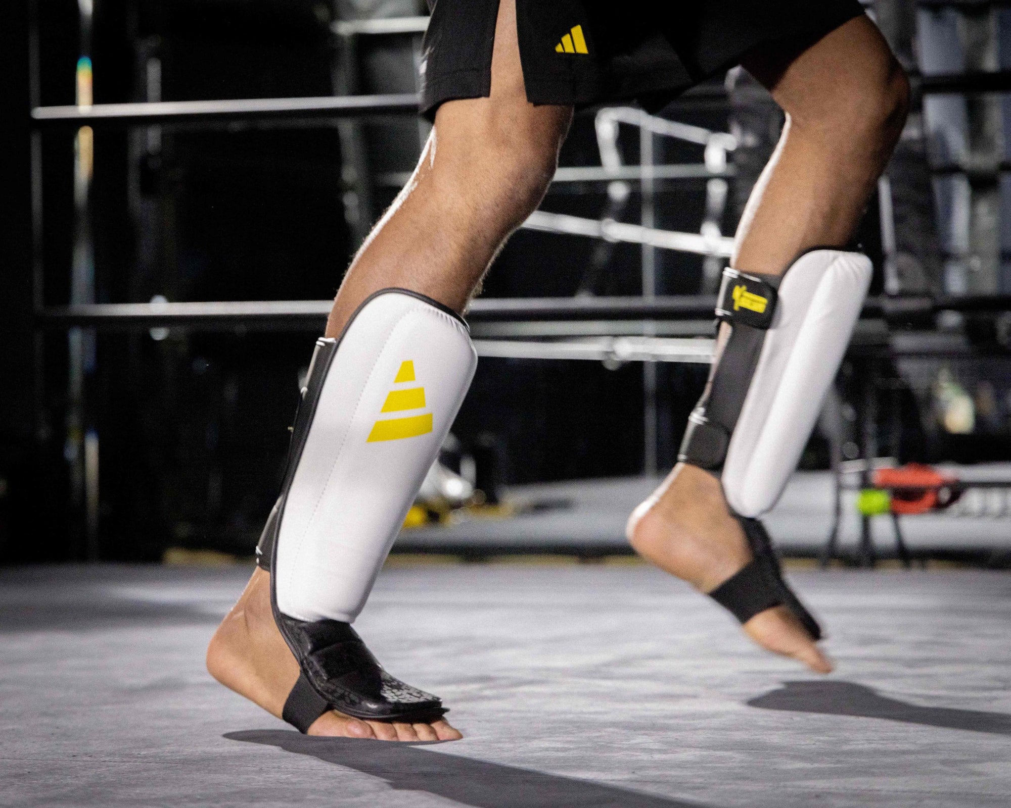 Person wearing black and yellow shin guards.