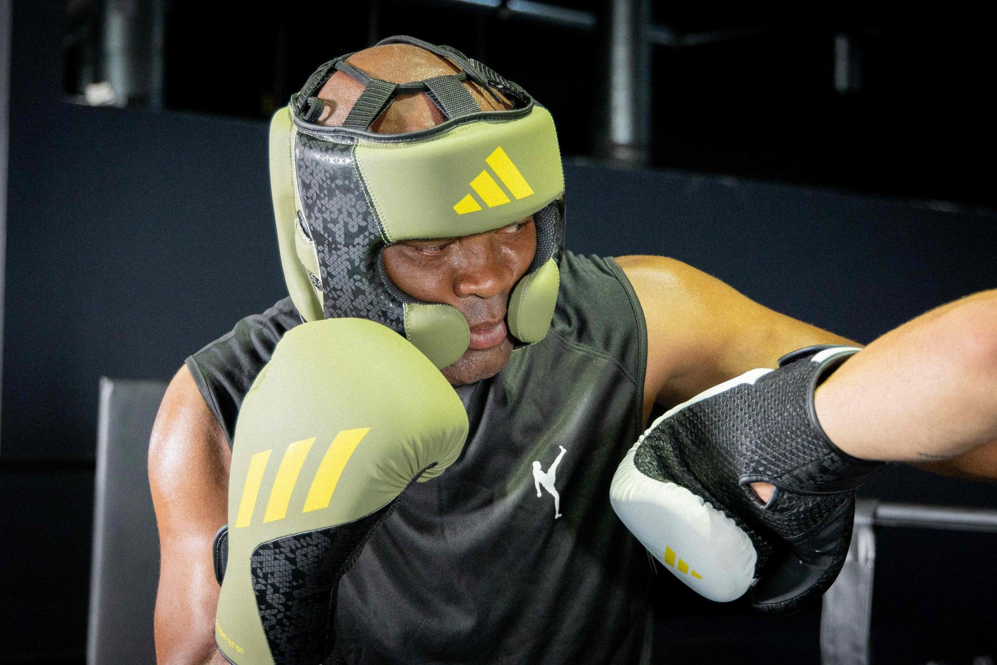 Man wearing boxing gloves from Adidas x Anderson Silva collection.