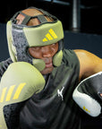 Man wearing boxing gloves from Adidas x Anderson Silva collection.