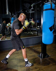 A man in boxing gloves in a gym.