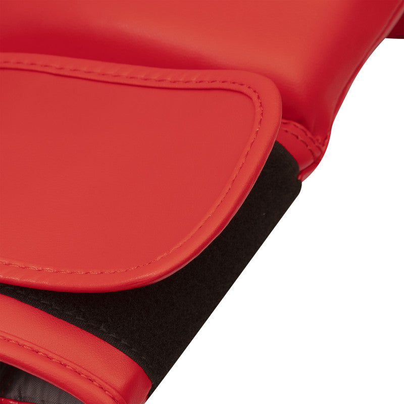 Close-up detail of a red boxing glove, highlighting quality materials.