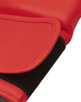 Close-up detail of a red boxing glove, highlighting quality materials.