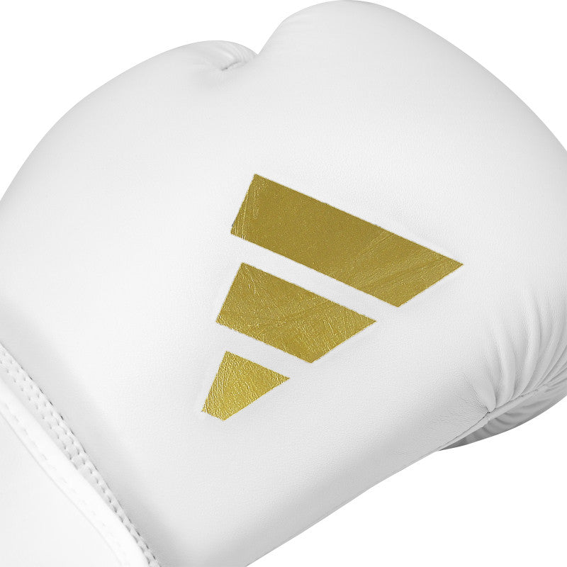 White boxing glove with a gold logo displayed against a neutral background.