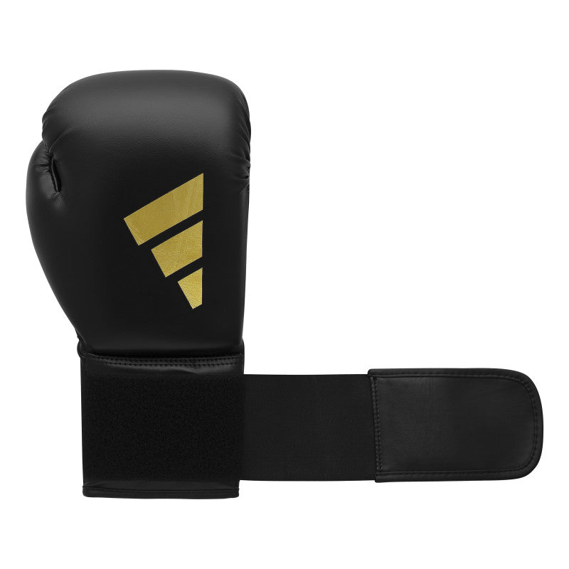 A black boxing glove with a black strap.