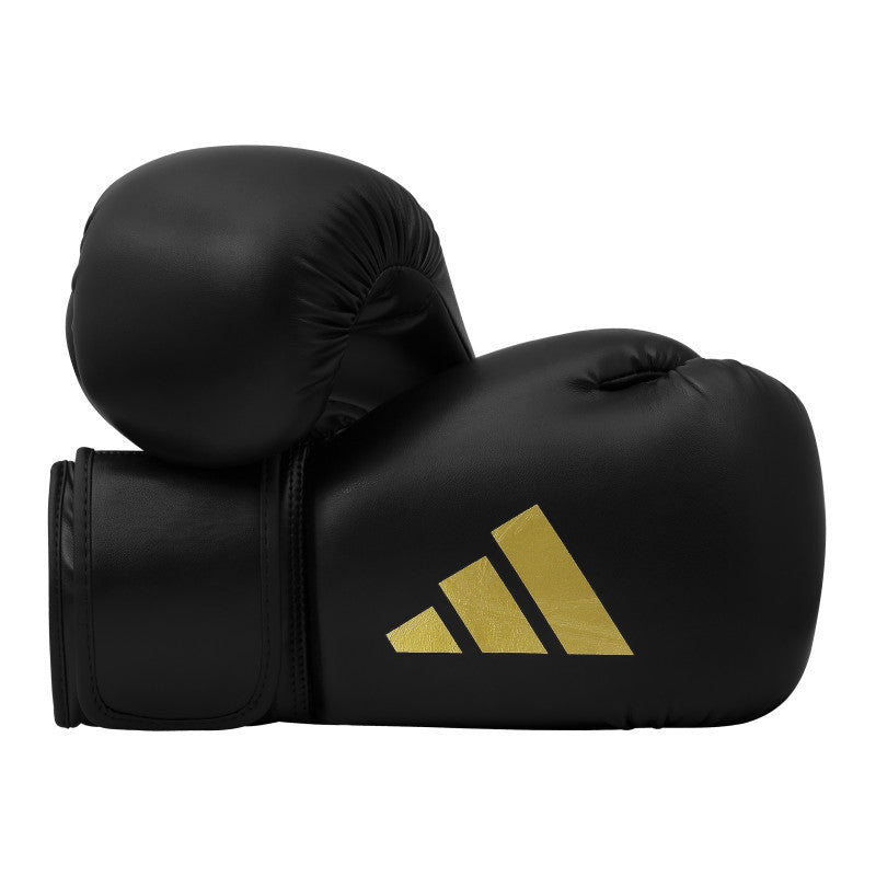 Pair of black and gold boxing gloves for boxing and kickboxing.