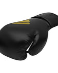 Black boxing glove with yellow stripes, adidas boxing gear.