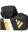 Pair of black and gold boxing gloves, Adidas Adi-Speed 500.