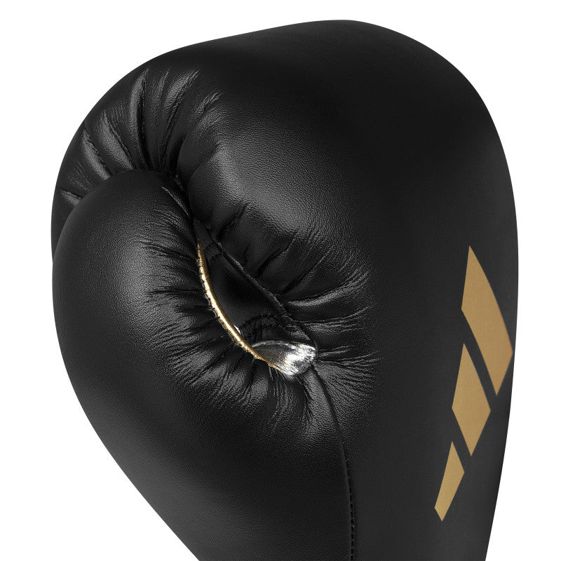 Black boxing glove with gold Adidas logo.