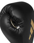 Black boxing glove with gold Adidas logo.