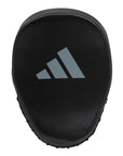 Black object with logo for boxing coaching equipment.