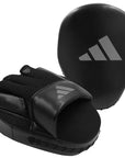 Black boxing glove and pad for training sessions.