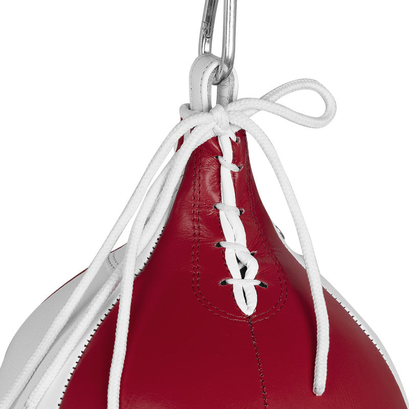 Red and white Adidas punching bag from close view.