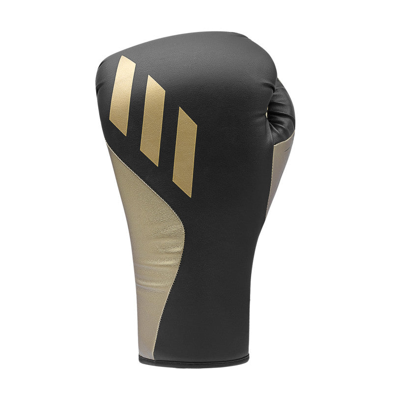 A black and gold boxing glove for training.