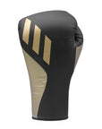 A black and gold boxing glove for training.