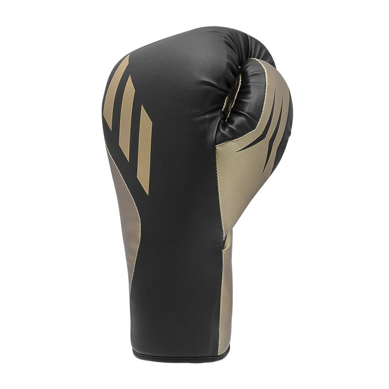 A black and gold boxing glove for training.