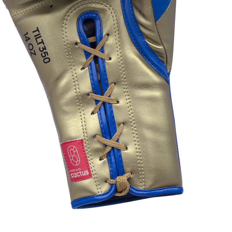 Close-up of a blue and gold boxing glove for Tilt 350 PRO Training.