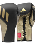 A pair of boxing gloves for training, lace-up design.