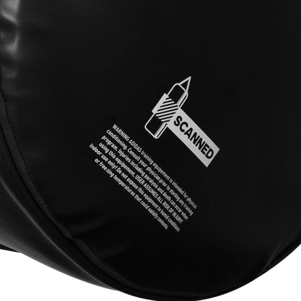 A black round Adidas bag with white text for boxing.