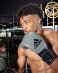 Man wearing boxing gloves, part of the adiSPEED 501 PRO series.